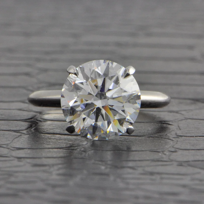 Emerald and diamond engagement ring in a vintage - inspired platinum bandGIA 4.16 ct. D-VVS2 Round Brilliant Cut Diamond Engagement Ring in Platinum Emerald and diamond engagement ring in a vintage - inspired platinum bandGIA 4.16 ct. D-VVS2 Round Brilliant Cut Diamond Engagement Ring in Platinum