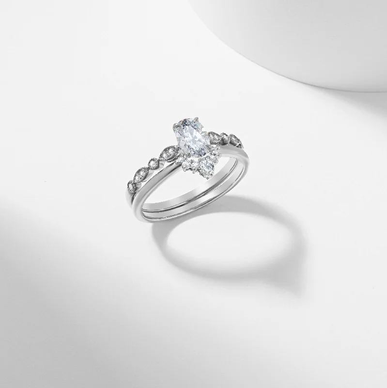 Round - cut diamond engagement ring with a twisted band design in 14K white goldOval Moissanite Tiara Bridal Set 0.97tdw Round - cut diamond engagement ring with a twisted band design in 14K white goldOval Moissanite Tiara Bridal Set 0.97tdw