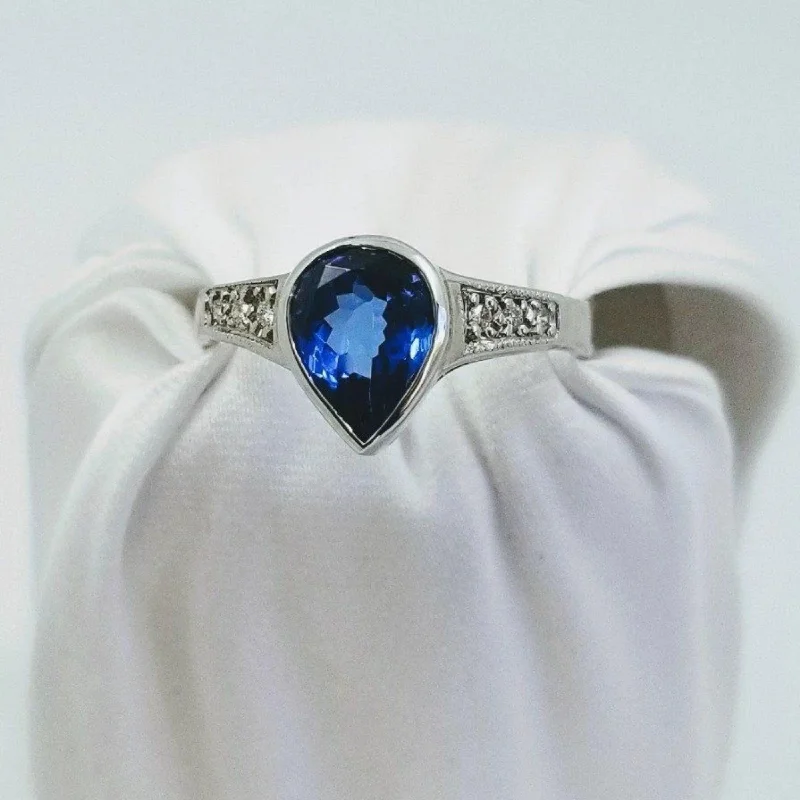 Engagement - Inspired Women's Rings with a Halo of Small DiamondsWhite Gold Pear shaped Tanzanite and Diamond ring Engagement - Inspired Women's Rings with a Halo of Small DiamondsWhite Gold Pear shaped Tanzanite and Diamond ring